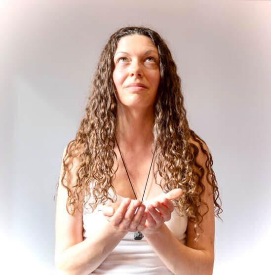Leah Fae, co-facilitator, her hands cupped in an open, receiving gesture